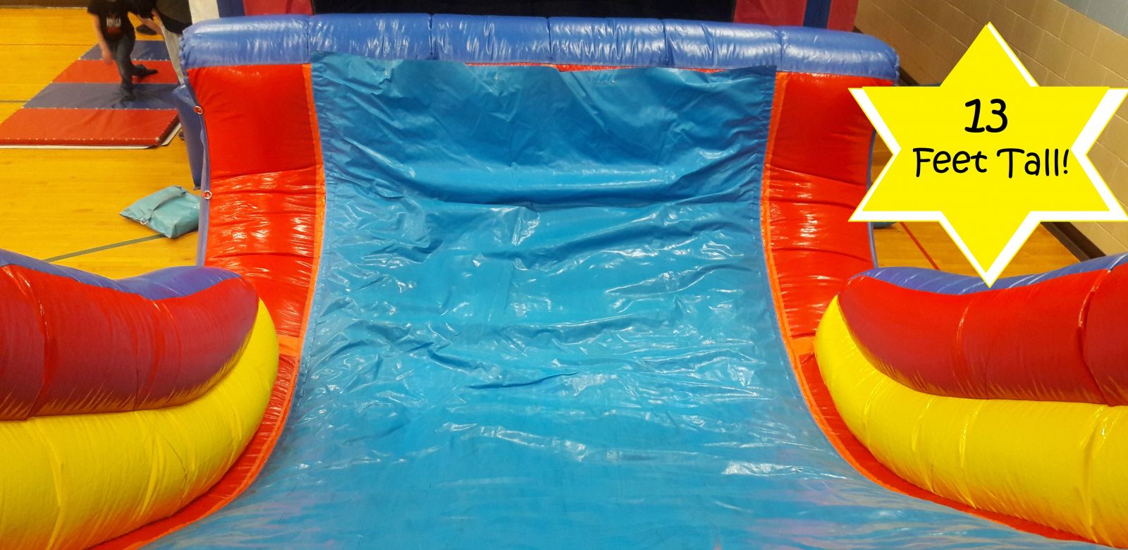 Slide view from the top of the climbing wall on the inflatable obstacle course